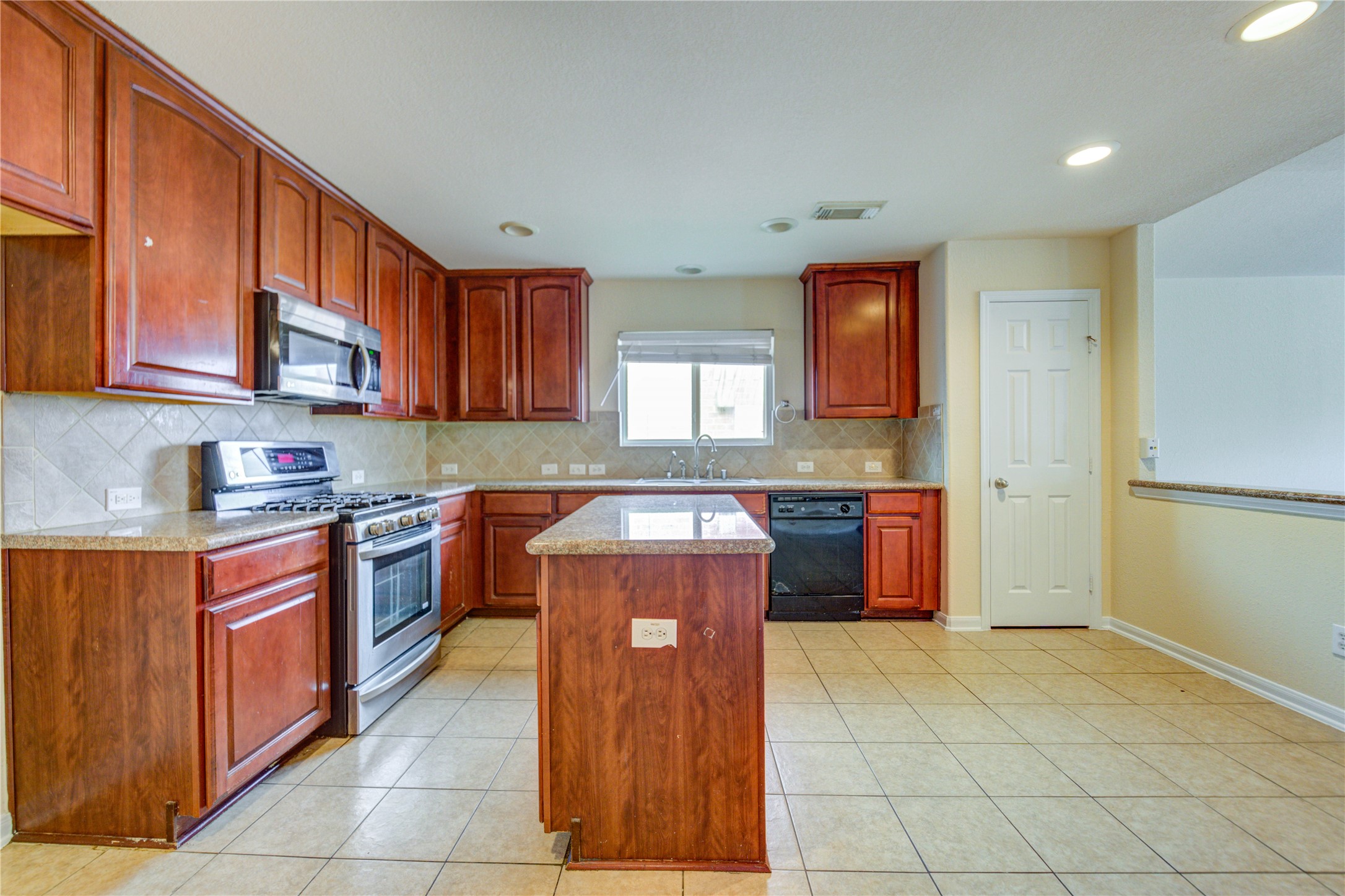 16718 Mackenzie Mesa Drive Spring, TX 77379 - Photo 23 of 50 a kitchen with stainless steel appliances granite countertop a stove a sink dishwasher and a refrigerator