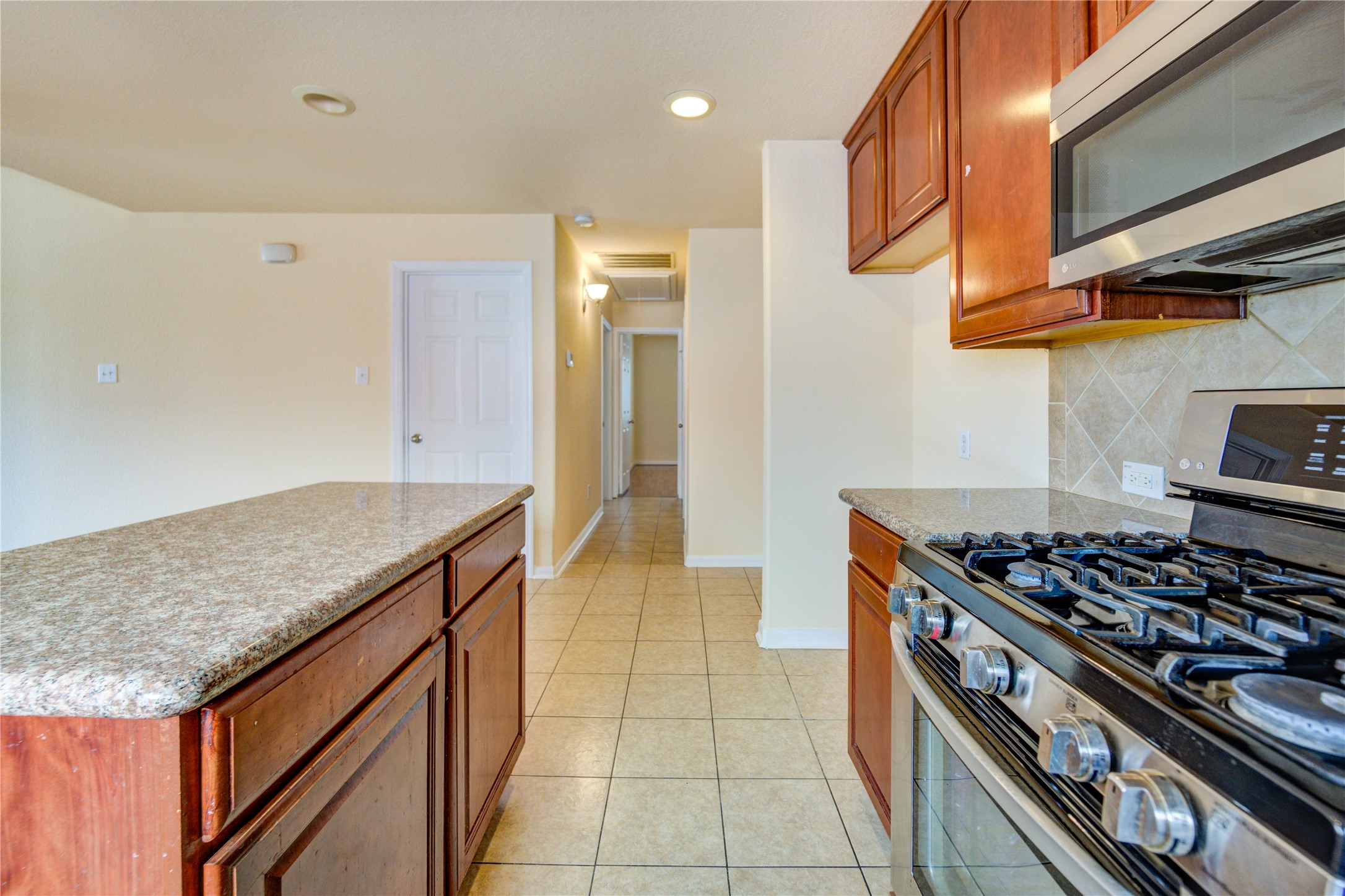 16718 Mackenzie Mesa Drive Spring, TX 77379 - Photo 24 of 50 a kitchen with stainless steel appliances granite countertop a stove and a sink