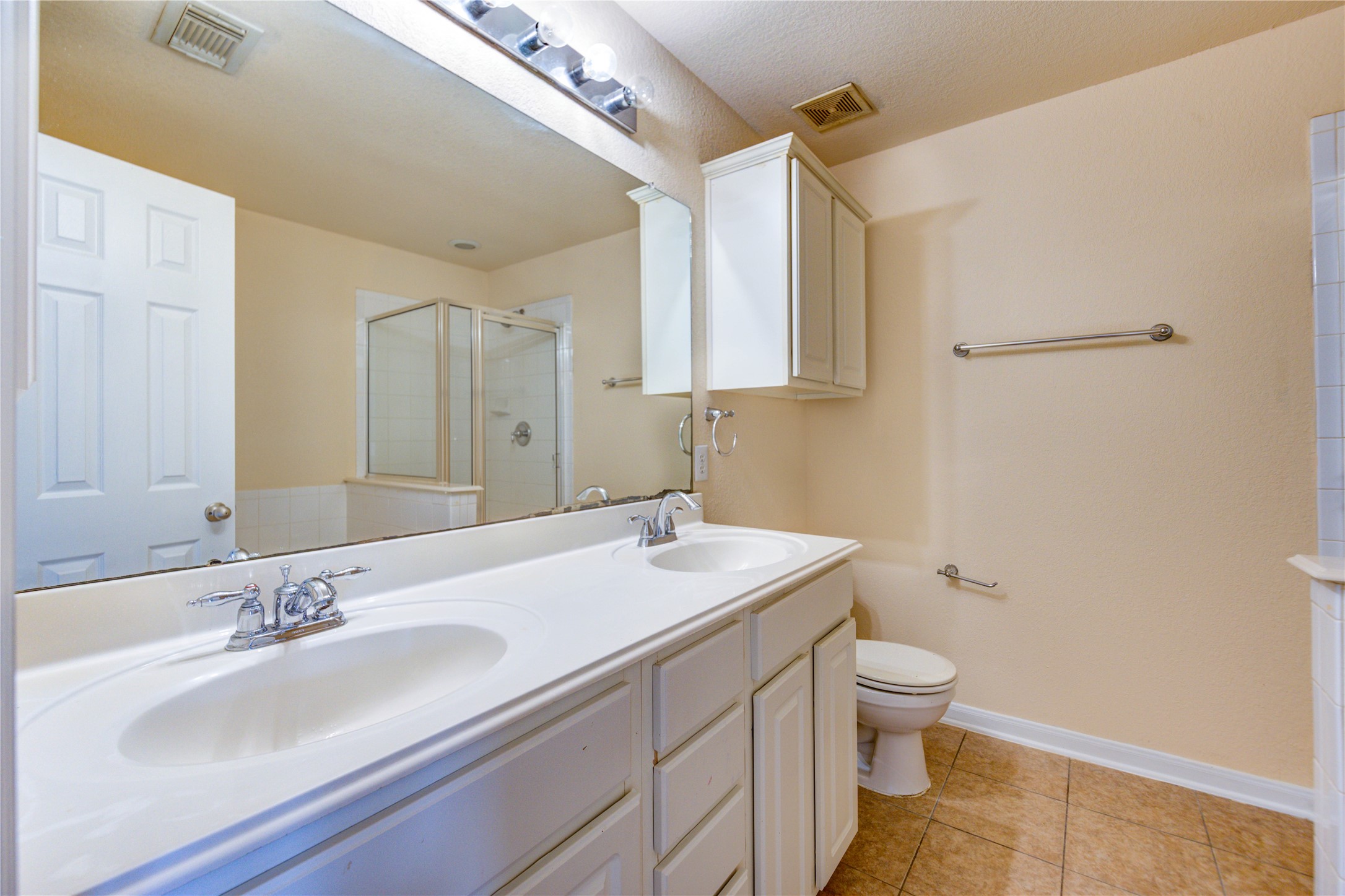 16718 Mackenzie Mesa Drive Spring, TX 77379 - Photo 30 of 50 a bathroom with a sink toilet and mirror