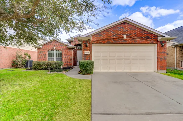 a large kitchen with stainless steel appliances granite countertop a stove top oven a sink dishwasher and a refrigerator