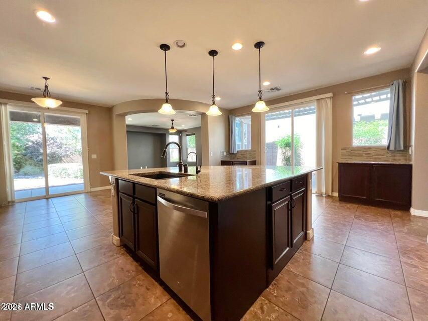 3886 East Rawhide Street Gilbert, AZ 85296 - Photo 12 of 52 a kitchen with stainless steel appliances granite countertop a sink and a large window
