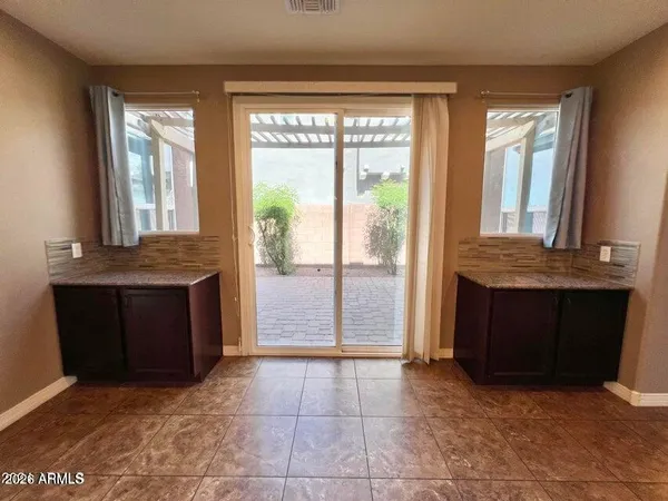 a view of kitchen with granite countertop cabinets and outdoor space