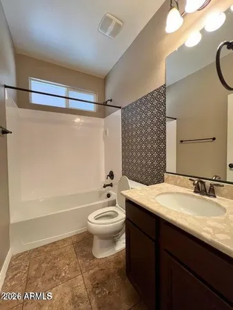 a bathroom with a sink a toilet a mirror and shower