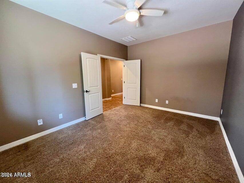 3886 East Rawhide Street Gilbert, AZ 85296 - Photo 21 of 52 an empty room with closet and fan