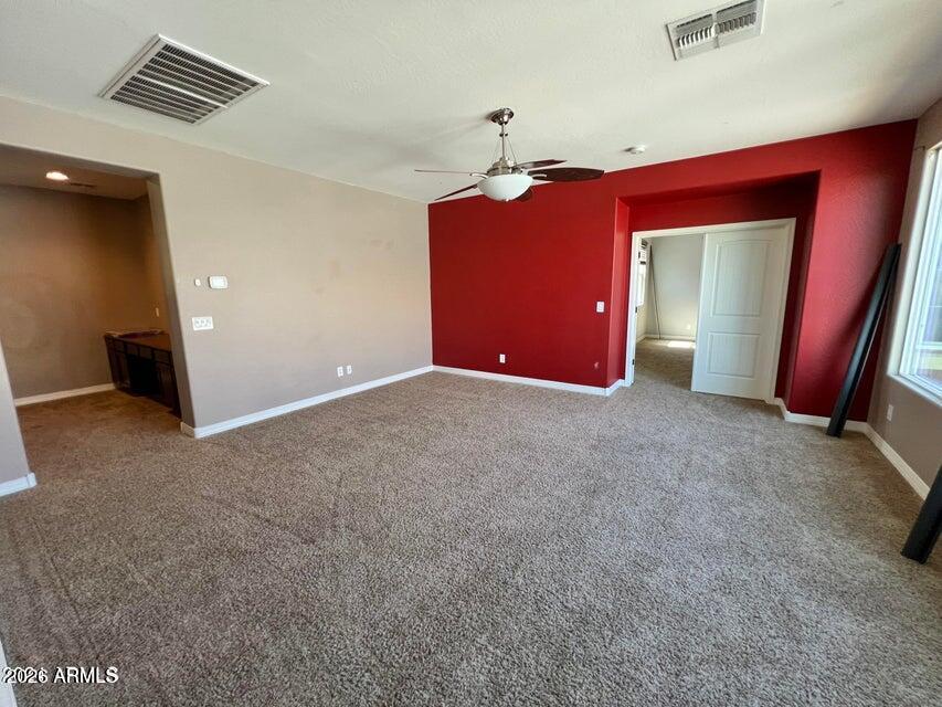 3886 East Rawhide Street Gilbert, AZ 85296 - Photo 23 of 52 a view of a livingroom with wooden floor and a ceiling fan