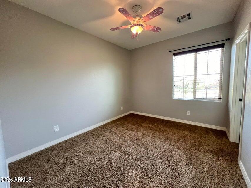 3886 East Rawhide Street Gilbert, AZ 85296 - Photo 26 of 52 an empty room with a window and a fan