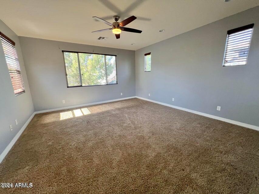 3886 East Rawhide Street Gilbert, AZ 85296 - Photo 30 of 52 an empty room with windows and fan