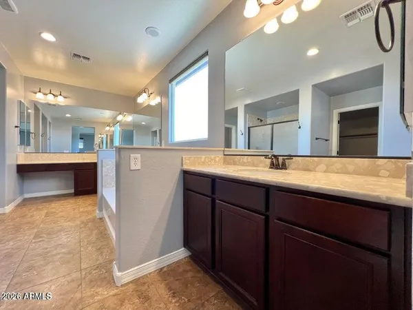 a bathroom with a sink a large mirror and a shower