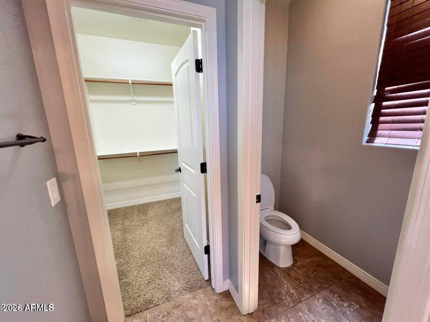 3886 East Rawhide Street Gilbert, AZ 85296 - Photo 40 of 52 a bathroom with a granite countertop toilet and a shower
