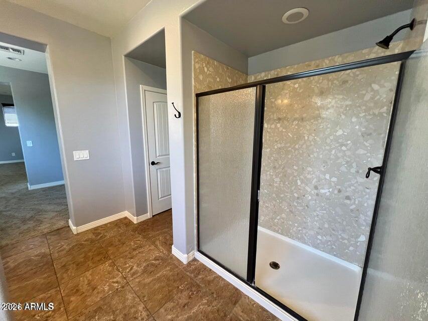 3886 East Rawhide Street Gilbert, AZ 85296 - Photo 42 of 52 a bathroom with a glass shower door and a sink