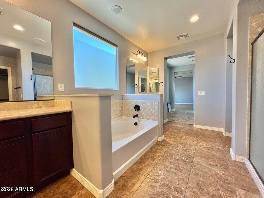 3886 East Rawhide Street Gilbert, AZ 85296 - Photo 43 of 52 a spacious bathroom with a tub sink and mirror