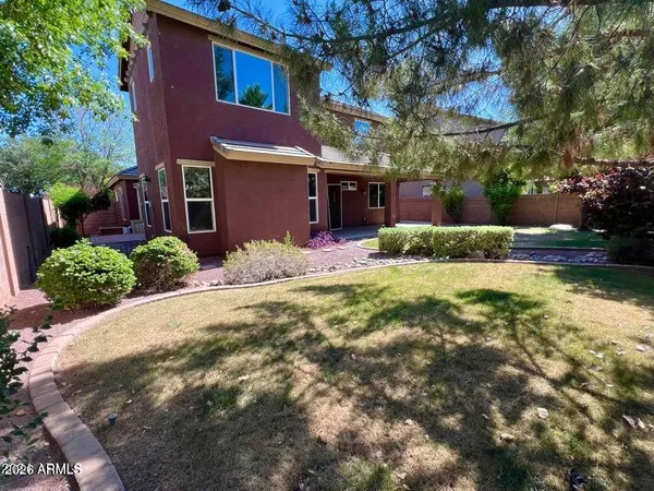 a view of a house with backyard and sitting area