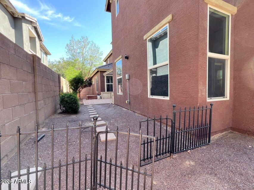 3886 East Rawhide Street Gilbert, AZ 85296 - Photo 52 of 52 a view of a brick house with many windows