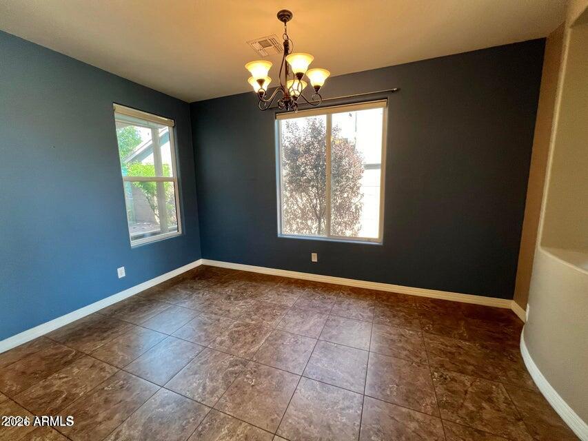 3886 East Rawhide Street Gilbert, AZ 85296 - Photo 7 of 52 a view of an empty room with window and chandelier fan