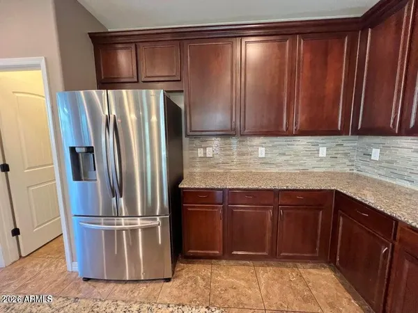 a kitchen with a refrigerator and cabinets