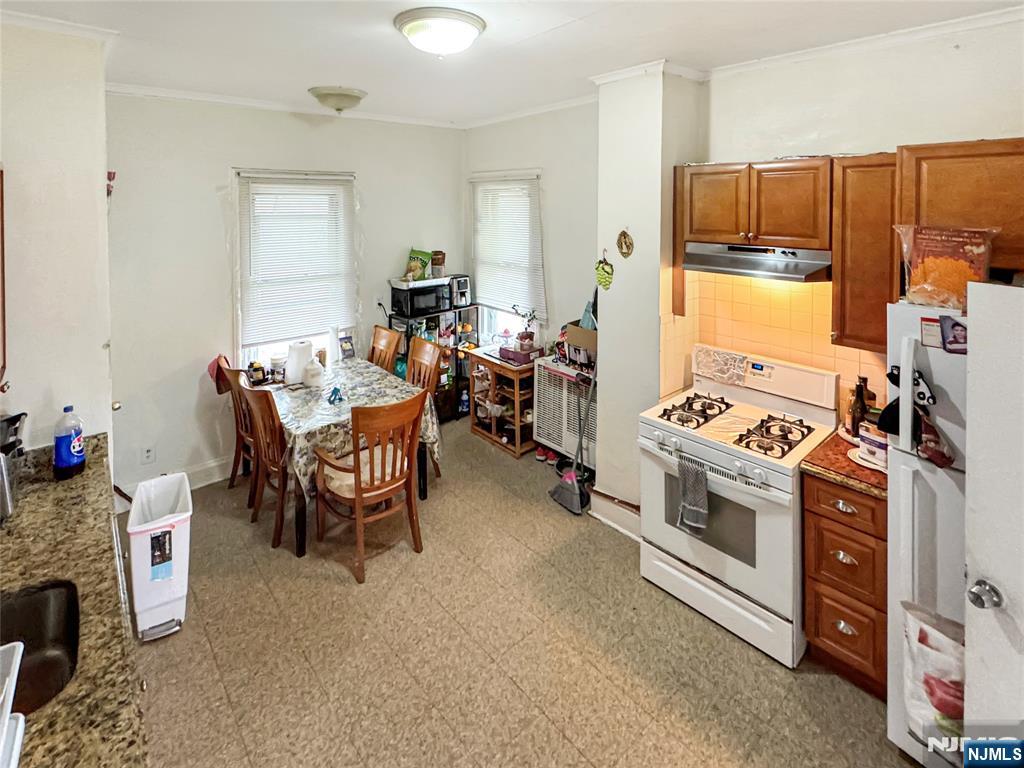 113 Kansas Street Hackensack, NJ 07601 - Photo 5 of 10 a kitchen with a stove and a refrigerator