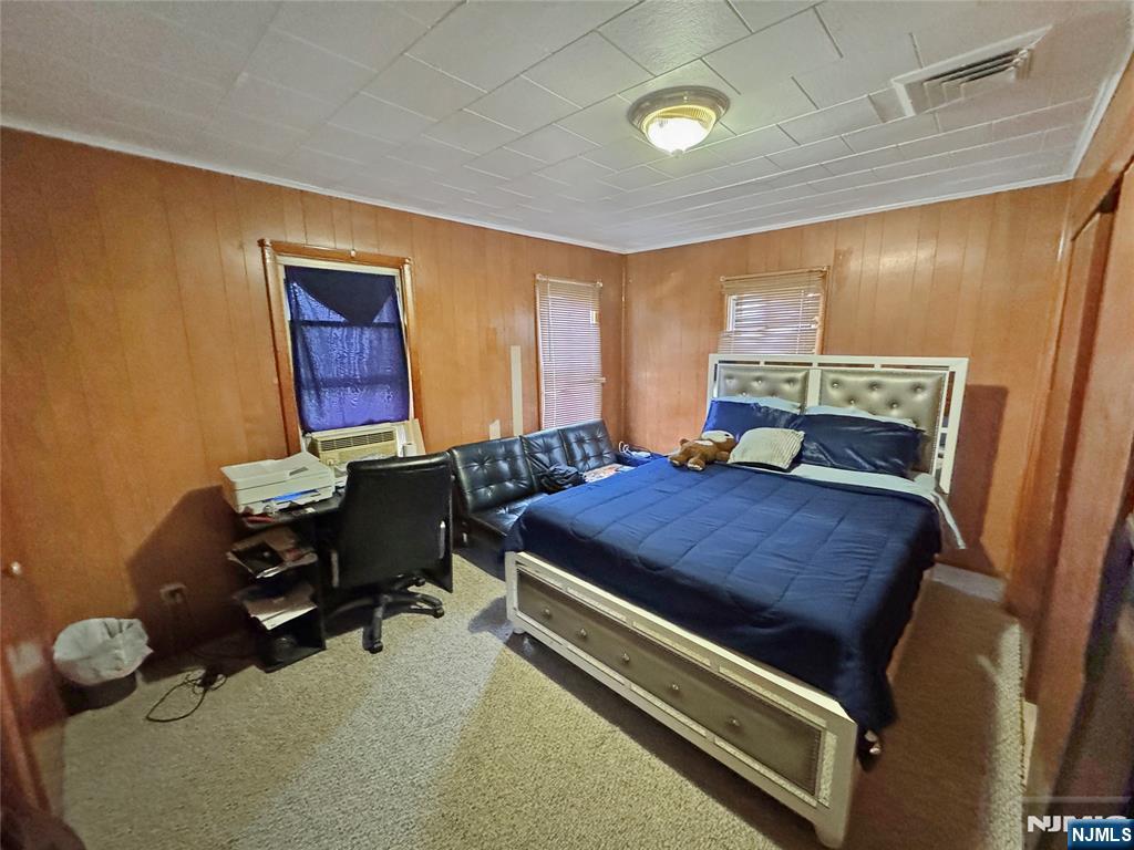 113 Kansas Street Hackensack, NJ 07601 - Photo 9 of 10 a bedroom with a bed and window