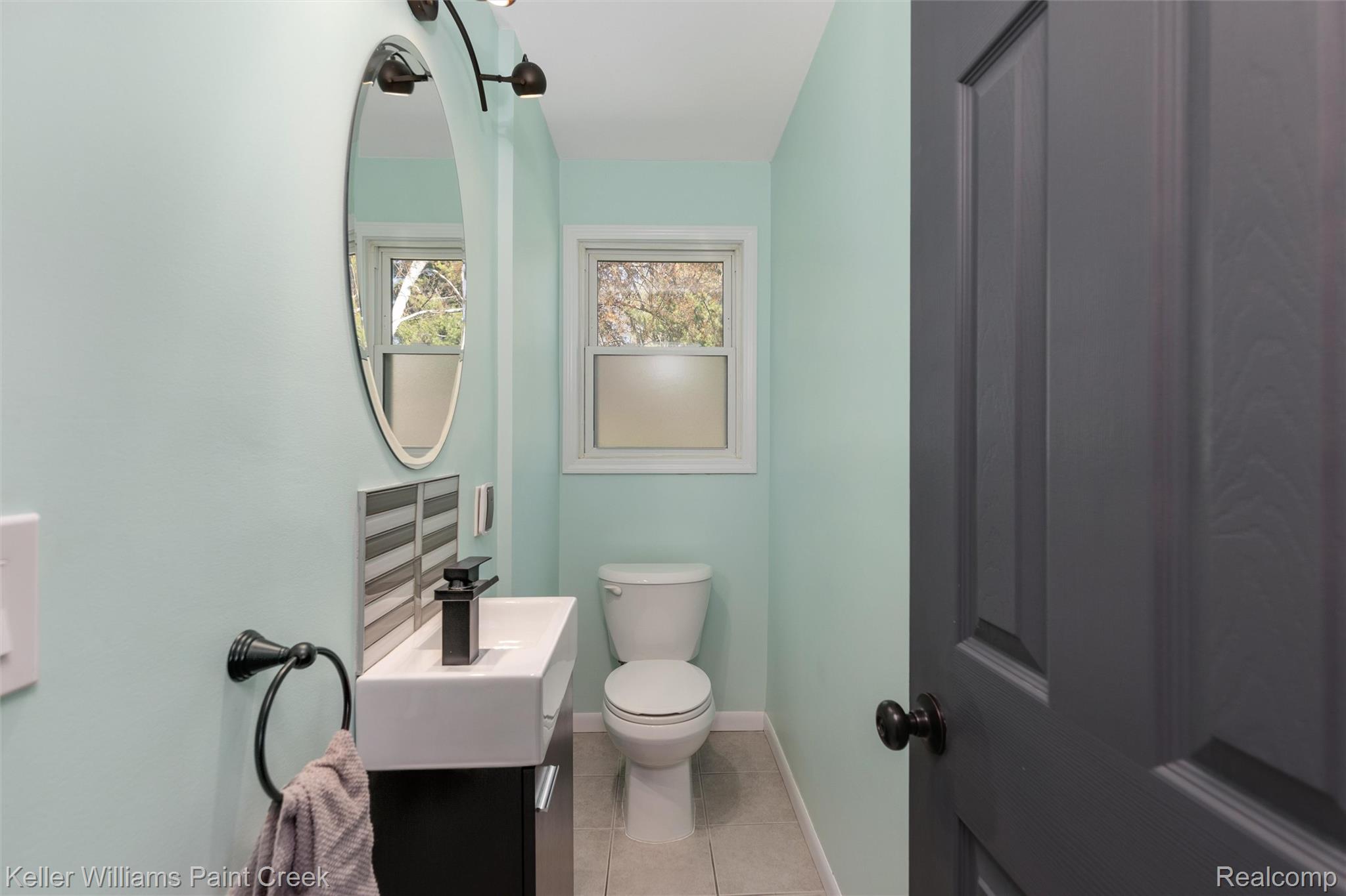 310 Elmhill Road Rochester, MI 48306 - Photo 19 of 37 Half bathroom featuring vanity and light tile patterned floors