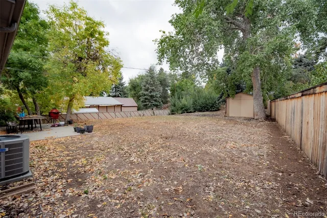 a view of a backyard with large trees