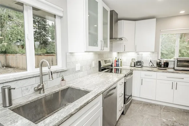a kitchen with a sink cabinets and window
