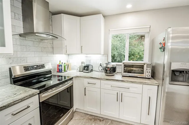 a kitchen with appliances a sink and cabinets