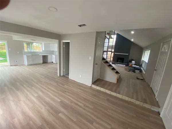 a view of a living room hardwood floor and a large window
