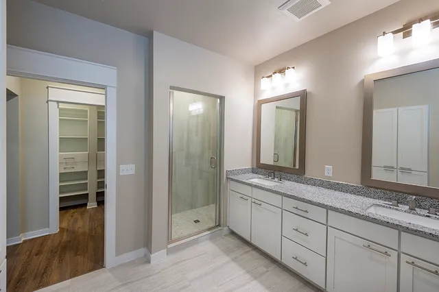 a bathroom with a granite countertop toilet a sink and bathtub