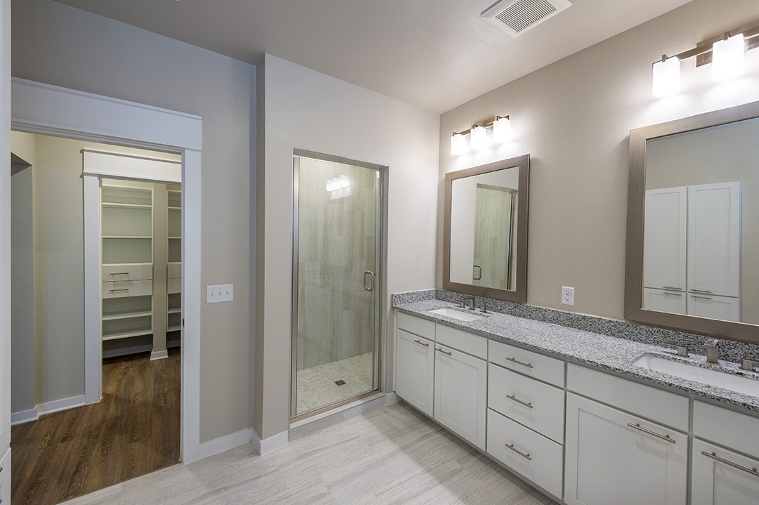 1724 Partnership Way, Unit 2102 Katy, TX 77449 - Photo 25 of 33 a spacious bathroom with a granite countertop sink mirror and shower