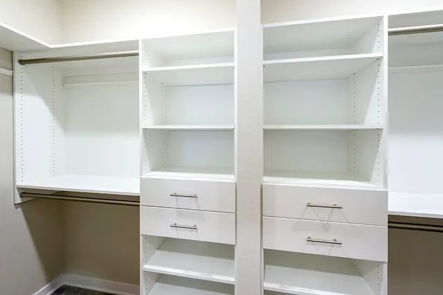 a spacious bathroom with a granite countertop sink mirror and shower