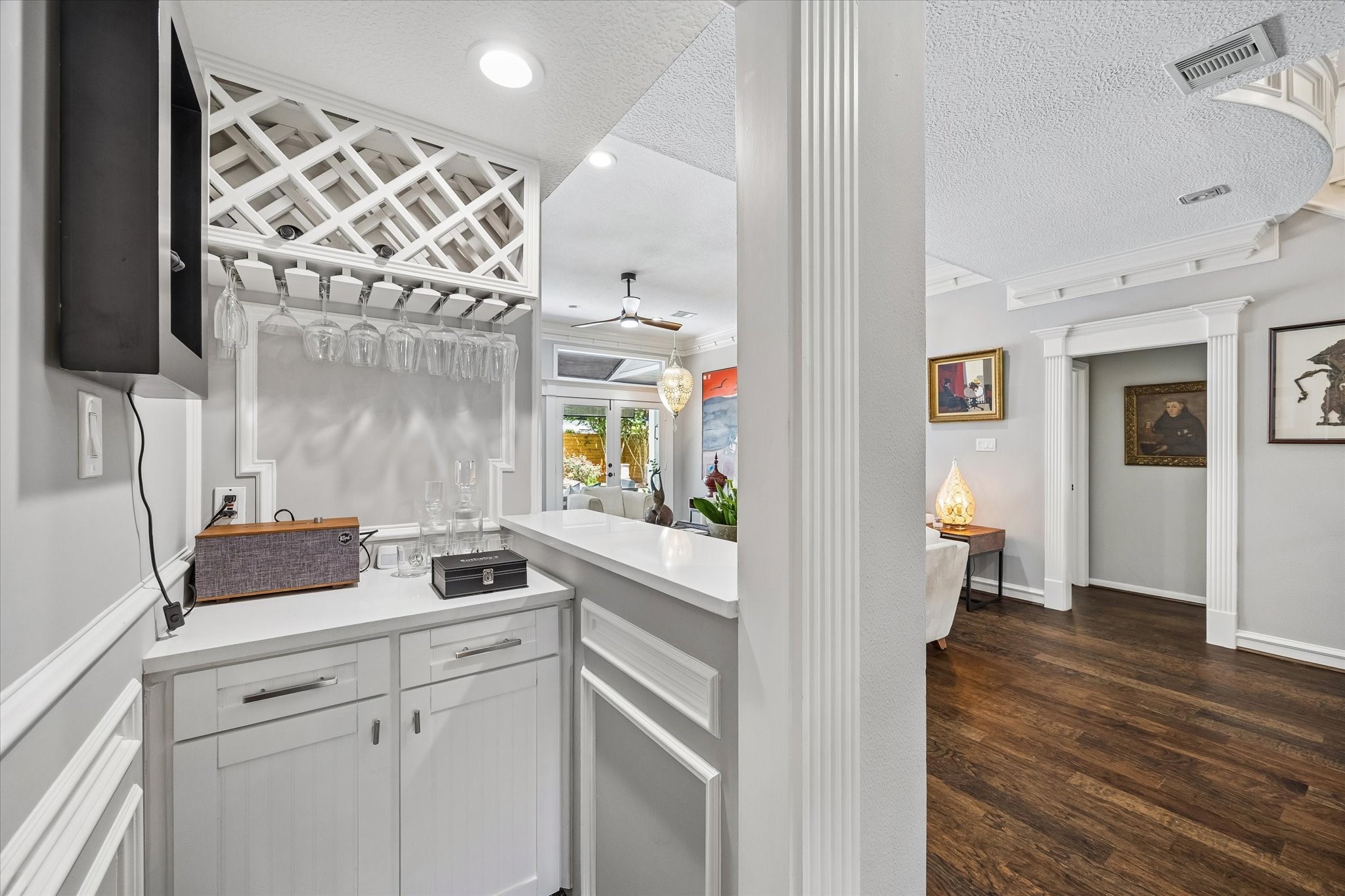 146 Golden Shadow Circle Spring, TX 77381 - Photo 13 of 41 Just off the dining room, the butler’s pantry offers additional serving space, storage for serving pieces, a hanging wine glass display, and dedicated wine storage for your favorite vintages.