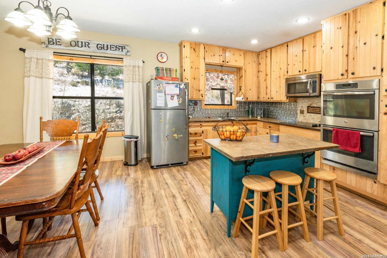 1079 County Road 357 Utopia, TX 78884 - Photo 11 of 36 a kitchen with stainless steel appliances granite countertop a table chairs stove and kitchen view