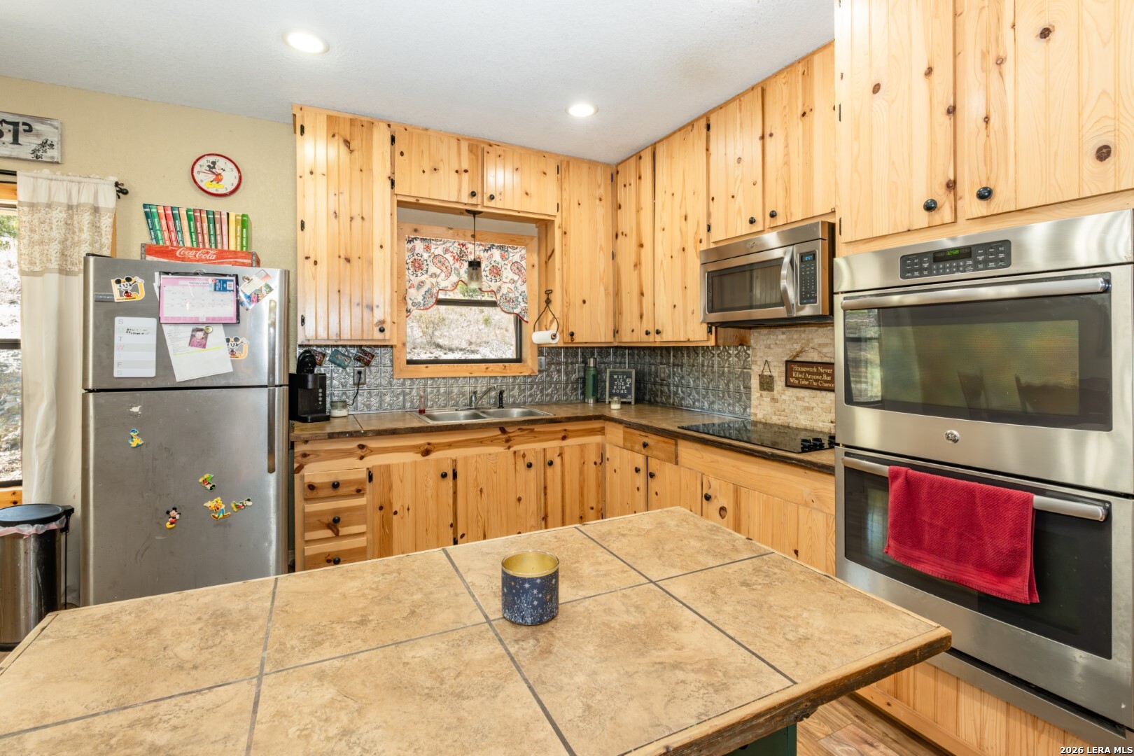 1079 County Road 357 Utopia, TX 78884 - Photo 12 of 36 a kitchen with stainless steel appliances a stove sink and cabinets