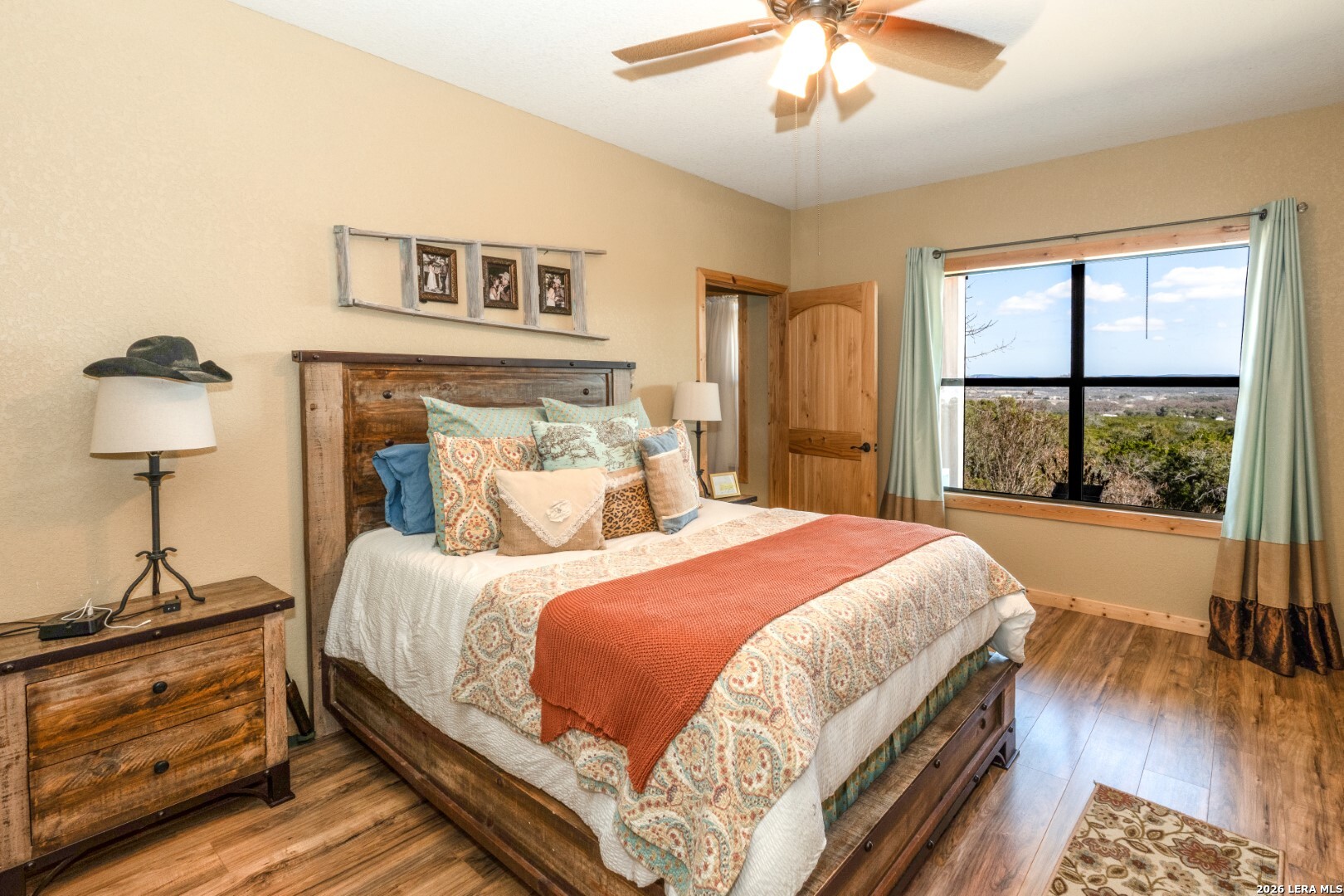 1079 County Road 357 Utopia, TX 78884 - Photo 14 of 36 a bedroom with a large bed and a chandelier