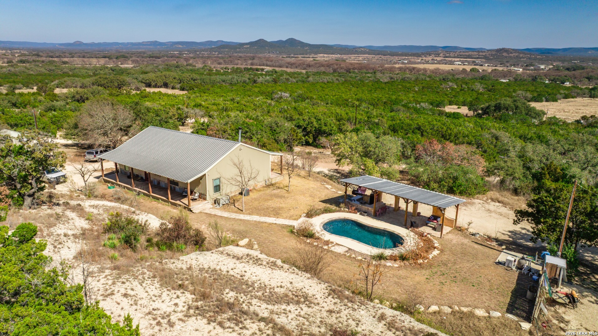 1079 County Road 357 Utopia, TX 78884 - Photo 2 of 36 a view of a terrace with a garden and mountain view
