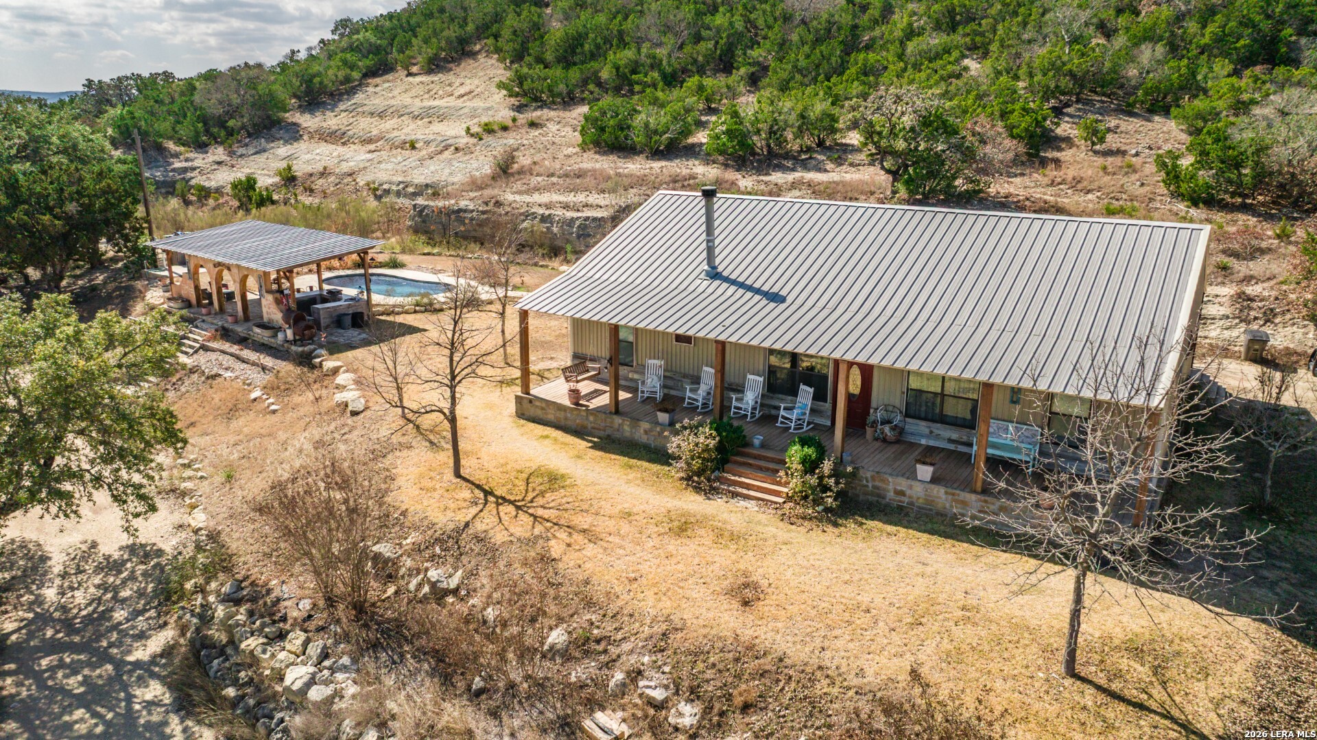 1079 County Road 357 Utopia, TX 78884 - Photo 29 of 36 a view of a house with a yard and sitting area