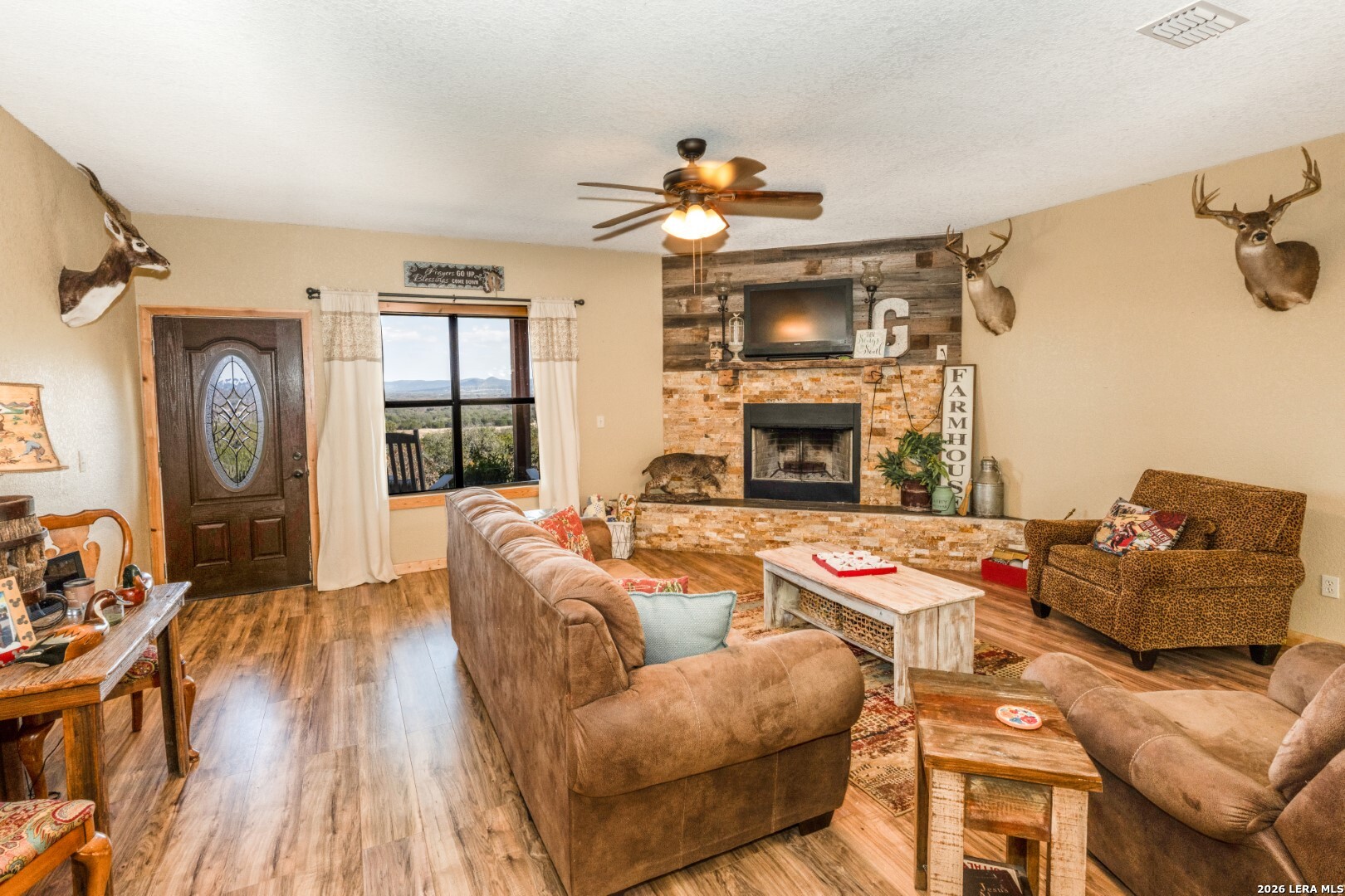 1079 County Road 357 Utopia, TX 78884 - Photo 6 of 36 a living room with furniture fireplace and flat screen tv
