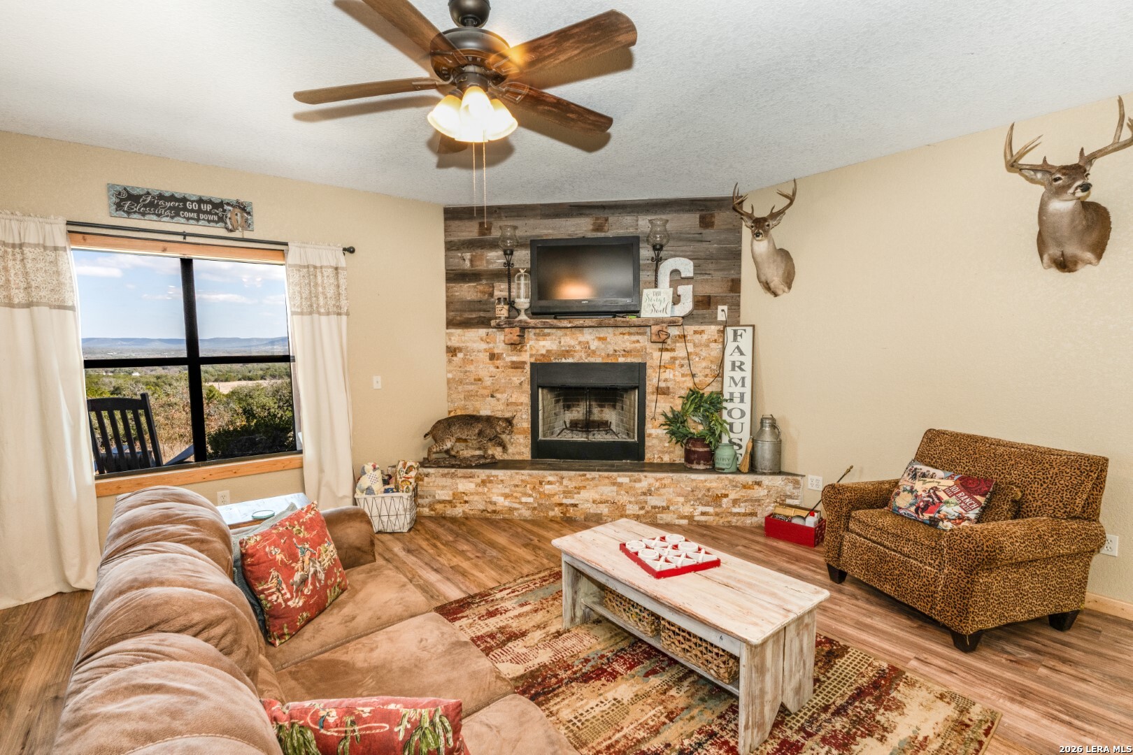 1079 County Road 357 Utopia, TX 78884 - Photo 7 of 36 a living room with furniture and a fireplace