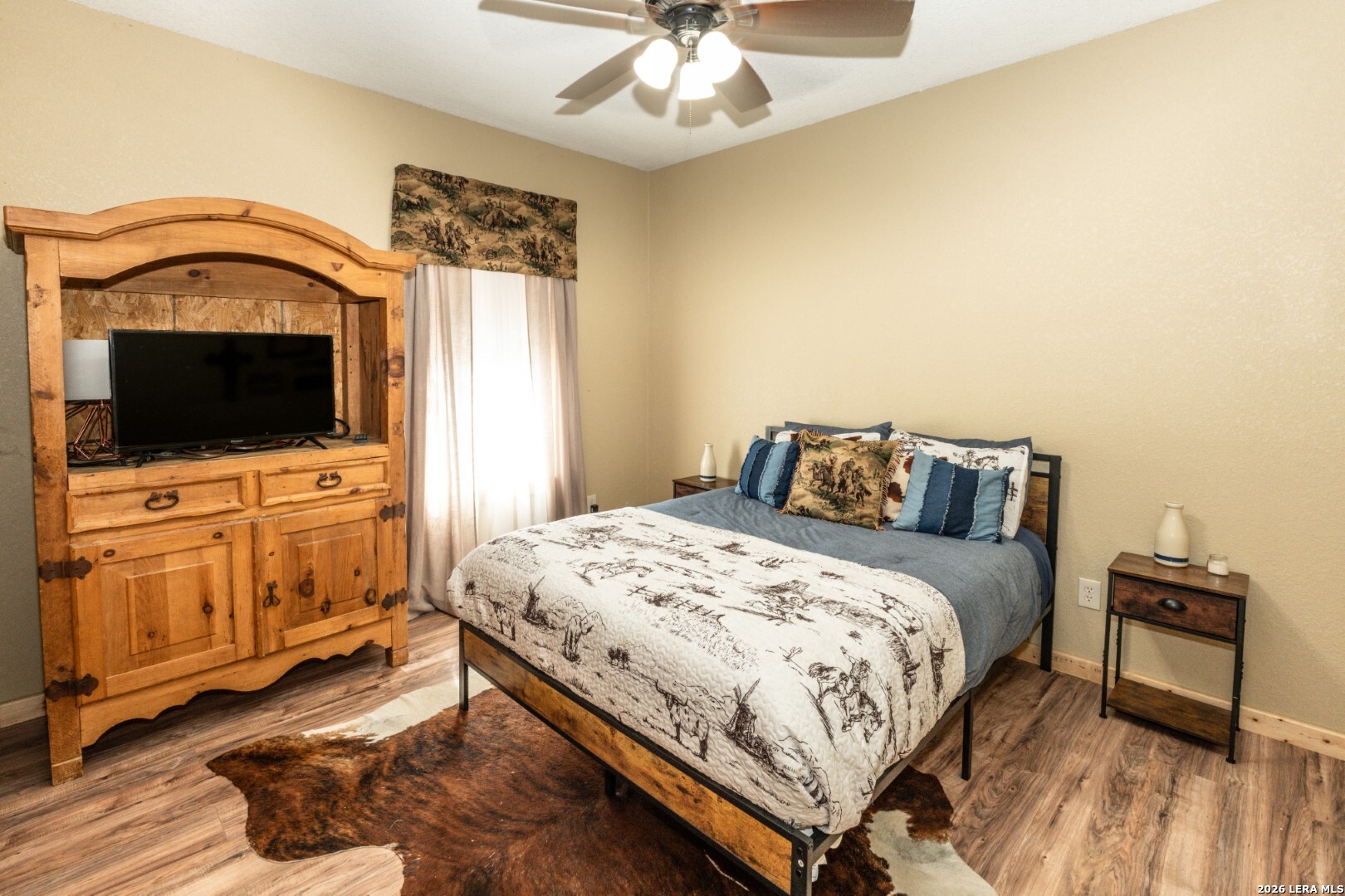 1079 County Road 357 Utopia, TX 78884 - Photo 8 of 36 a bedroom with a bed and flat tv screen on dresser