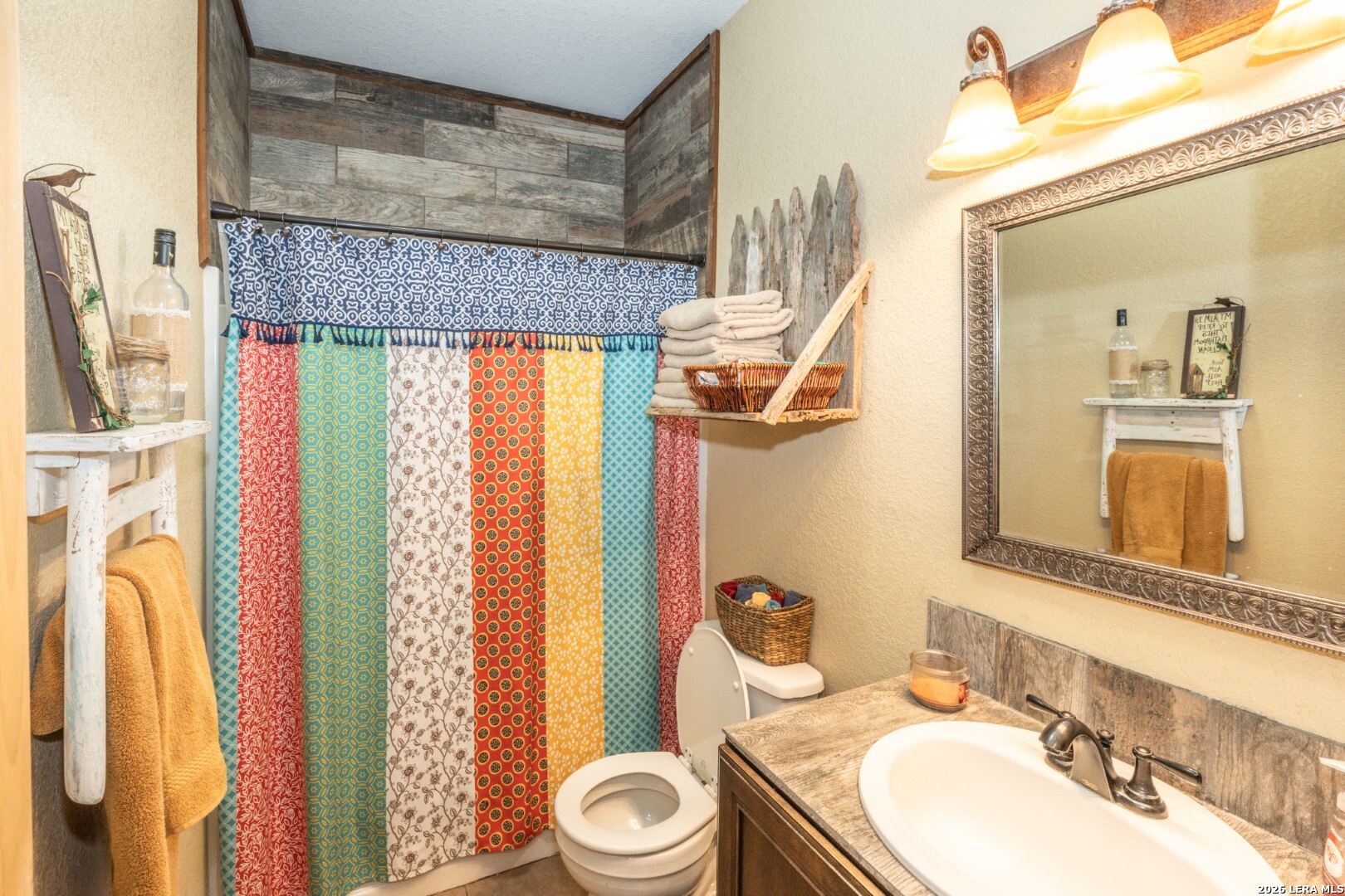 1079 County Road 357 Utopia, TX 78884 - Photo 10 of 36 a bathroom with a sink a toilet and a mirror