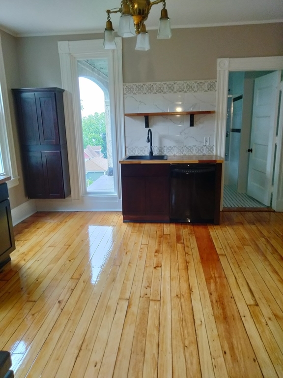 764 Rock Street, Unit 2 Fall River, MA 02720 - Photo 14 of 17 a view of kitchen island wooden floors wooden cabinets