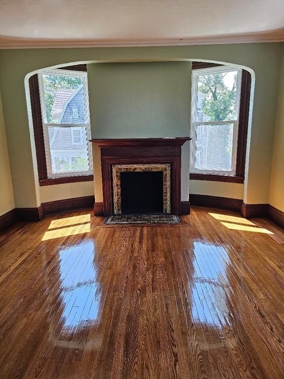 764 Rock Street, Unit 2 Fall River, MA 02720 - Photo 10 of 17 a living room with a fireplace and wooden floor