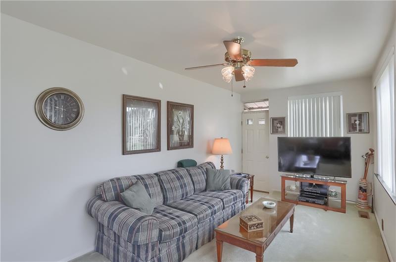 203 Gass Road Pittsburgh, PA 15229 - Photo 12 of 25 Enjoy the family room featuring vivid windows and access to the rear yard.