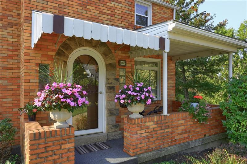 Great guests on the charming front porch featuring an arched front entryway.  