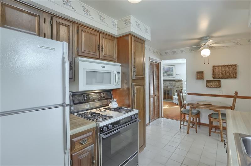 203 Gass Road Pittsburgh, PA 15229 - Photo 10 of 25 The kitchen provides access to the living room and has a large pantry and eat in dining area.