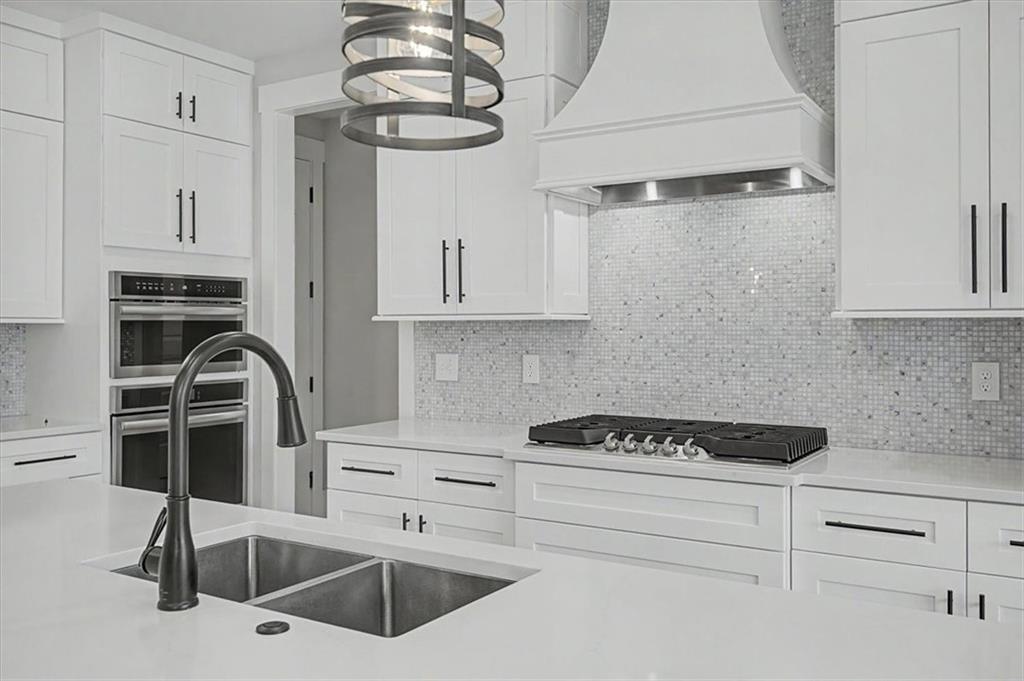 217 Laura Lake Road Marietta, GA 30066 - Photo 24 of 54 a kitchen with white cabinets and appliances