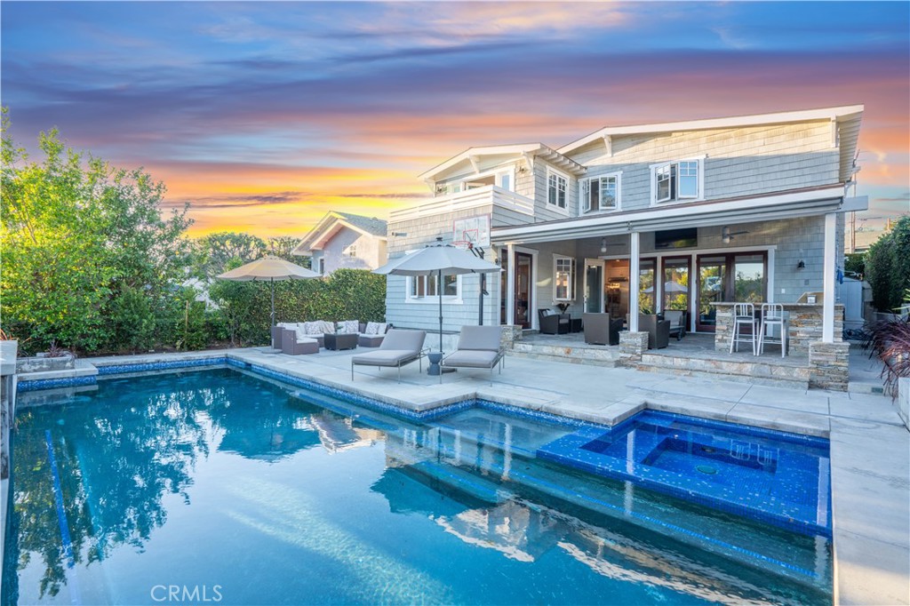 a view of a house with pool and chairs