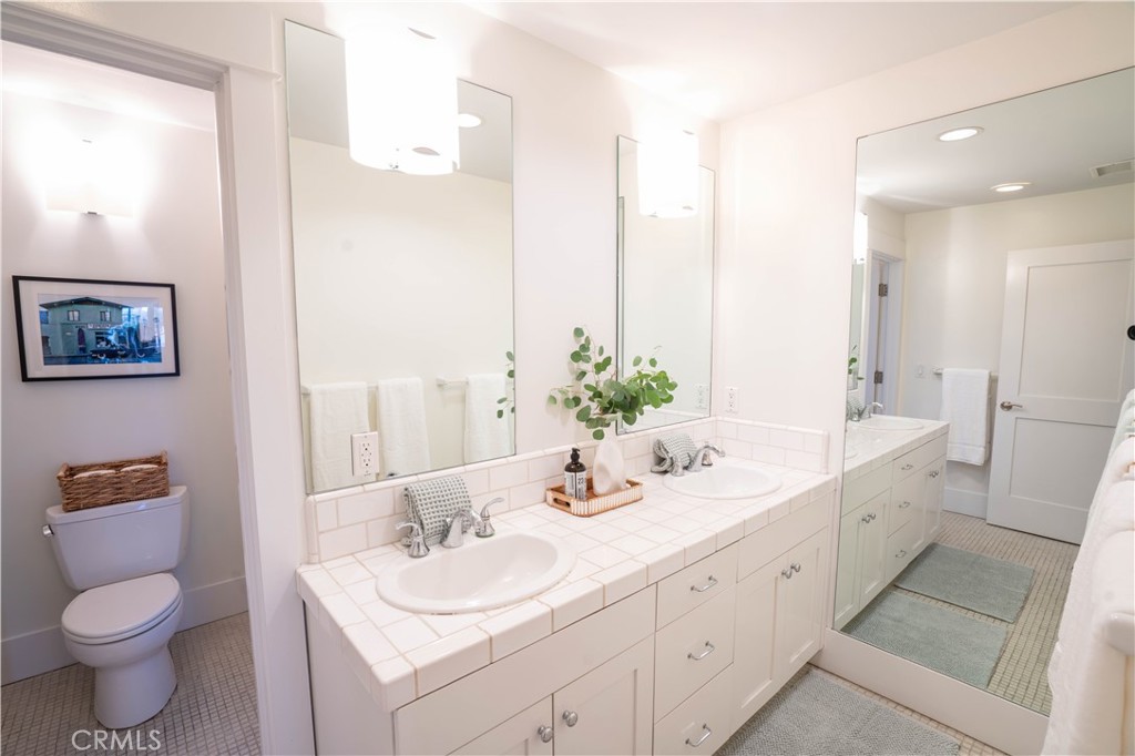 562 24th Place Hermosa Beach, CA 90254 - Photo 31 of 75 a bathroom with a double vanity sink toilet and a mirror