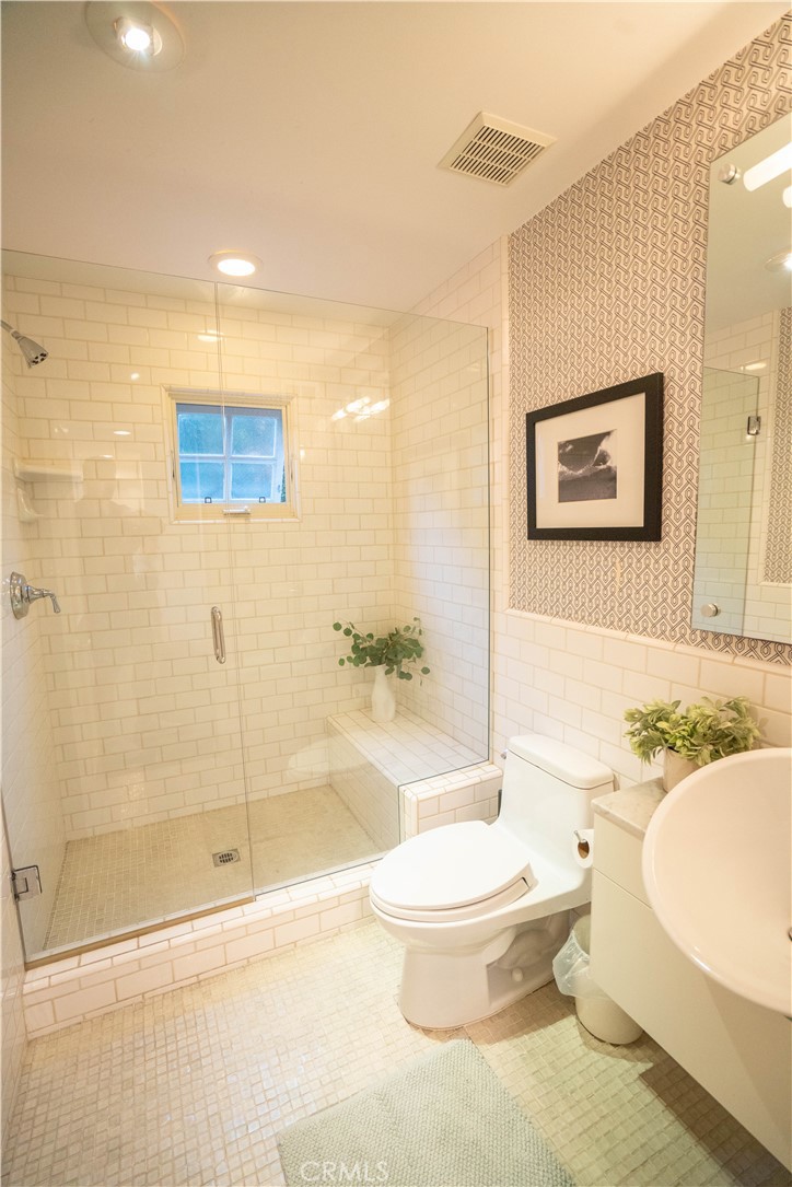 562 24th Place Hermosa Beach, CA 90254 - Photo 50 of 75 a white toilet sitting next to a bathroom sink and a shower