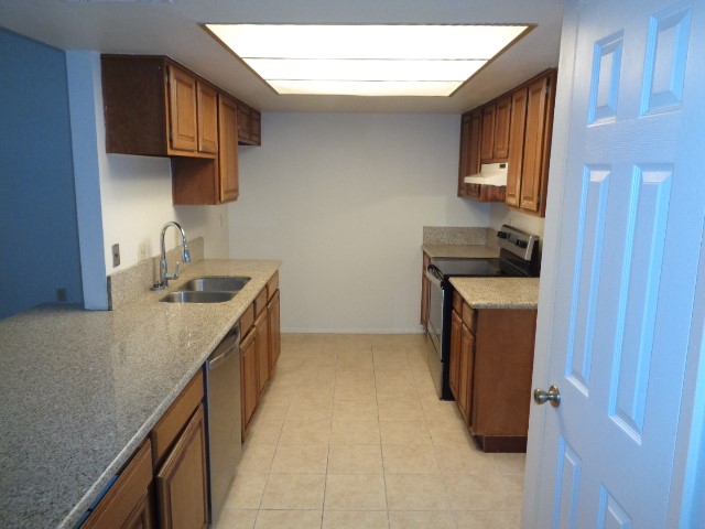 9530 Magnolia Ridge Drive Houston, TX 77070 - Photo 18 of 20 a kitchen with a sink stove top oven and cabinets