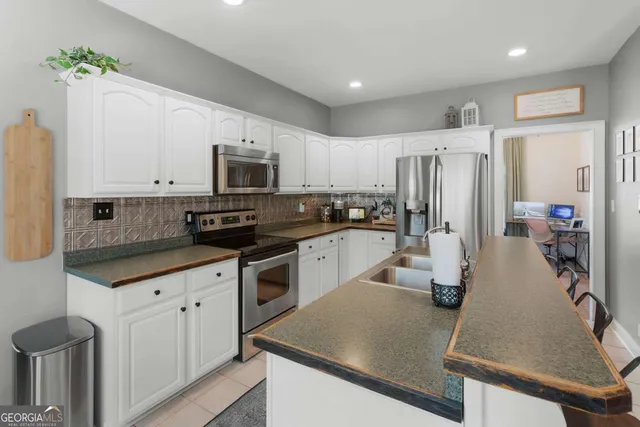 a kitchen with refrigerator and cabinets